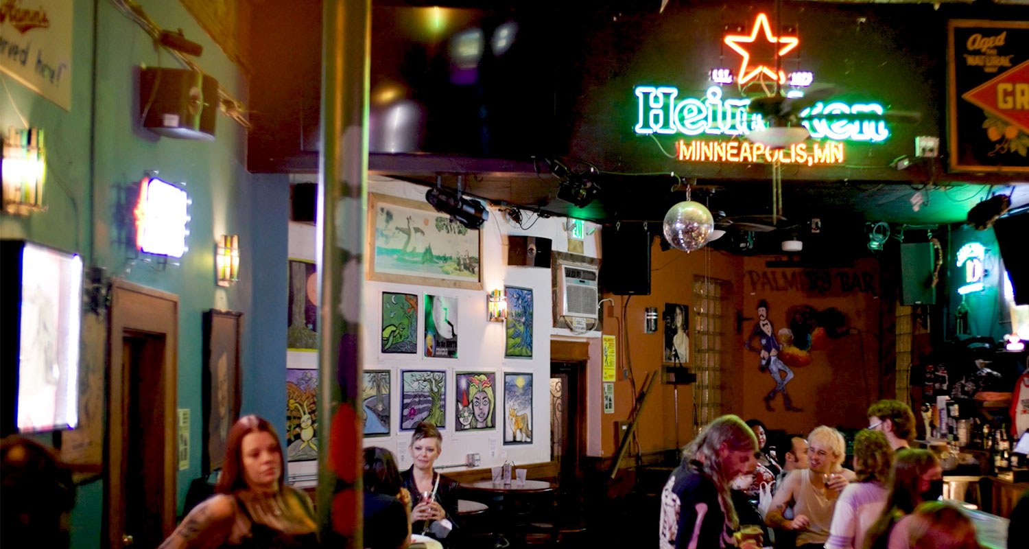 people drinking at dive bar